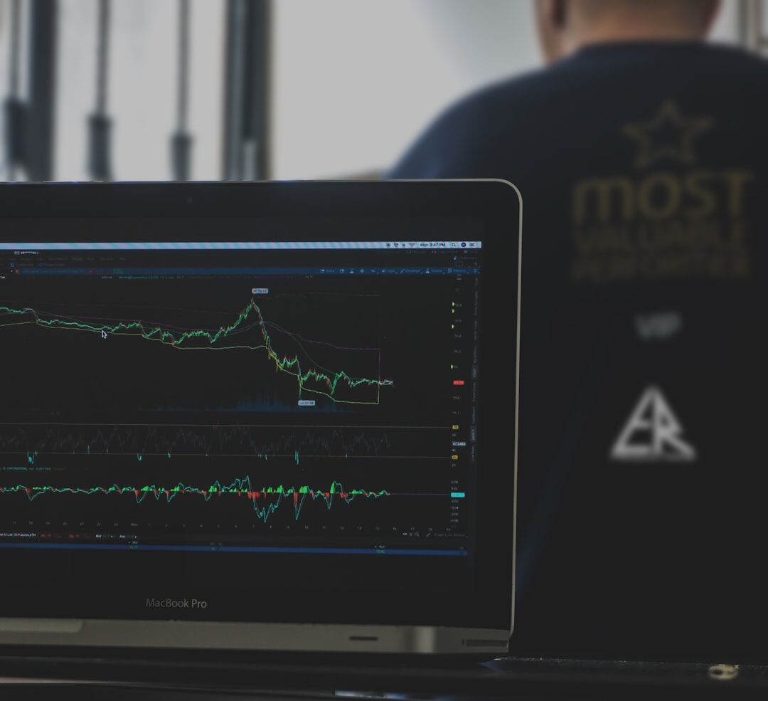 Belgian financial analyst reviewing market charts on multiple screens in a Brussels office